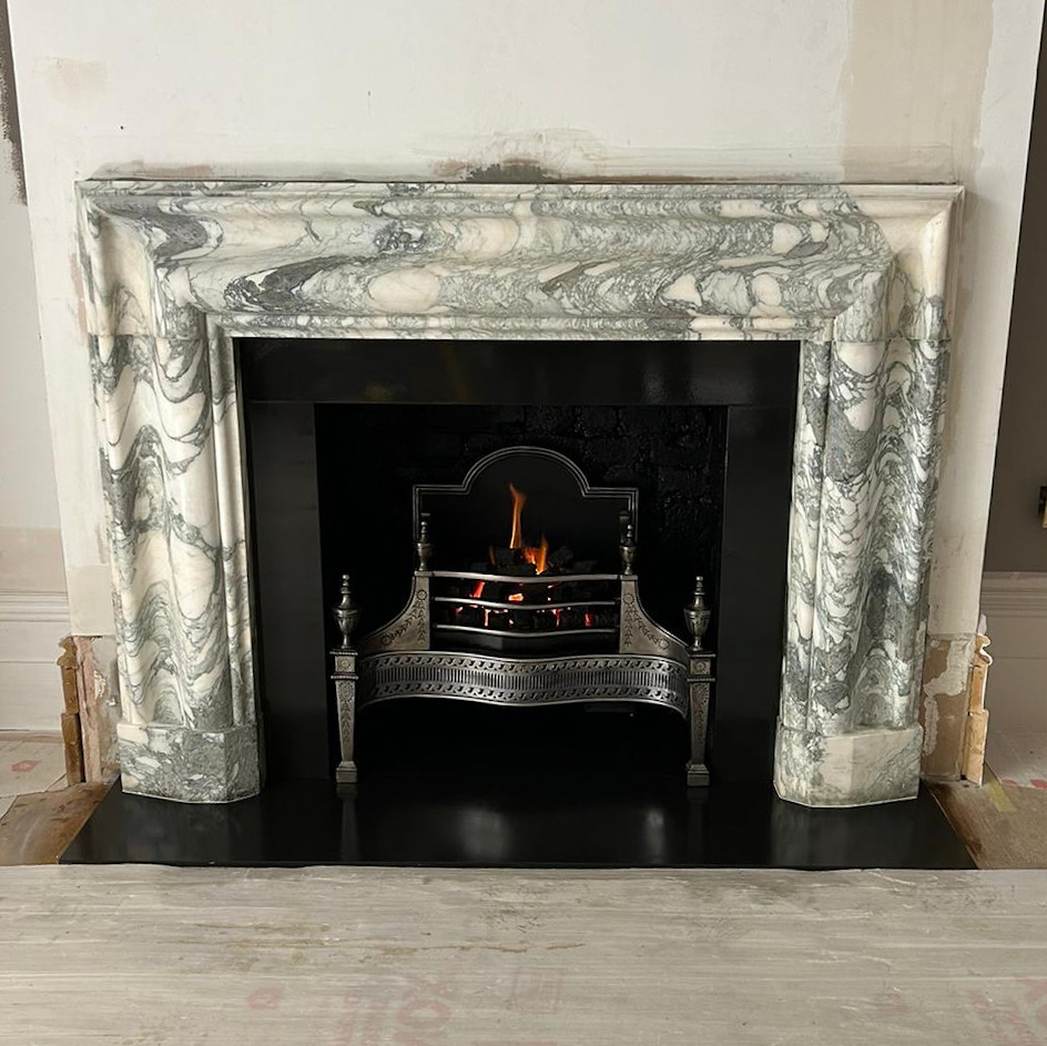 Green marble "Bolection" mantel, polished basket, gas fire